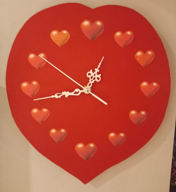 Heart-Shaped Wall Clock is a romantic mixed-media piece measuring approximately 25x25cms